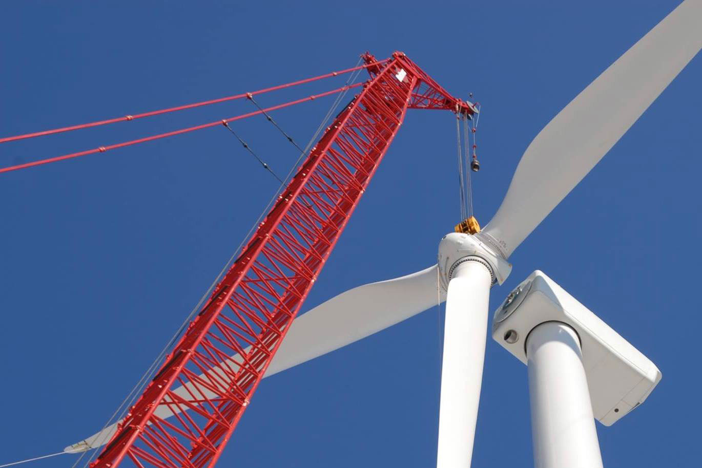 A crane assembling a wind turbine